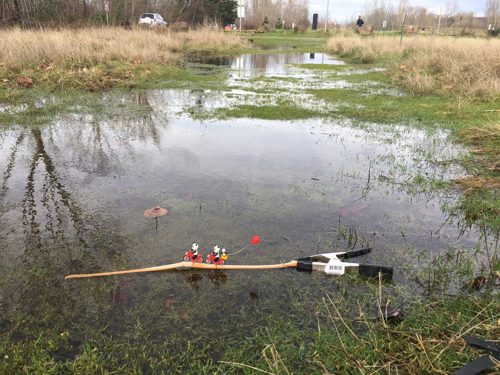 Behind the scenes set up of a lego pandas riding bikes across a puddle