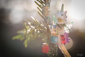 LEGO Unicorn Fairy with wings decorates a christmas tree from on top of a LEGO Ladder, photo by Shelly Corbett