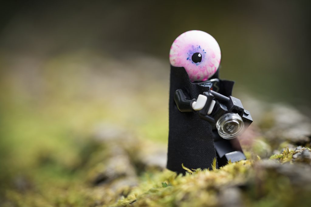 Custome LEGO mini figure with eyeball for a head holds a camera. Custom by Dennis Taylor, Photo by Shelly Corbett