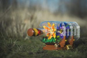 LEGO Flowers grow in the winter sun inside the LEGO Ship in a Bottle. Photo by Shelly Corbett