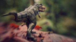 A Papo toy dinosaur rampages across the landscape. Photo taken by Shelly Corbett with a Lensbaby