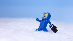 blue LEGO benny spaceman holds camera by James Garcia
