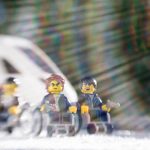 three lego men in wheelchairs in front of an oncoming train taken with a lensbaby by shelly corbett