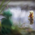 A blurry LEGO swamp monster hides in the bushes and watches the bathing beauty in the lake - taken with a LensBaby by Shelly Corbett