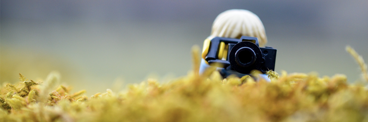 LEGO minifigure taking photos in moss
