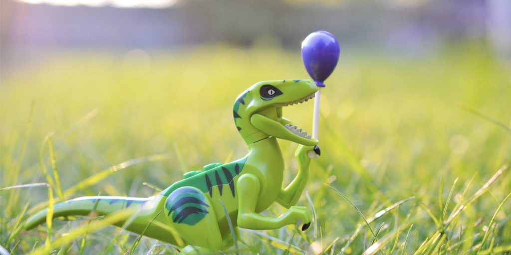 LEGO dinosaur holding a balloon