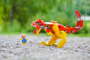 LEGO dinosaur chasing a piggy