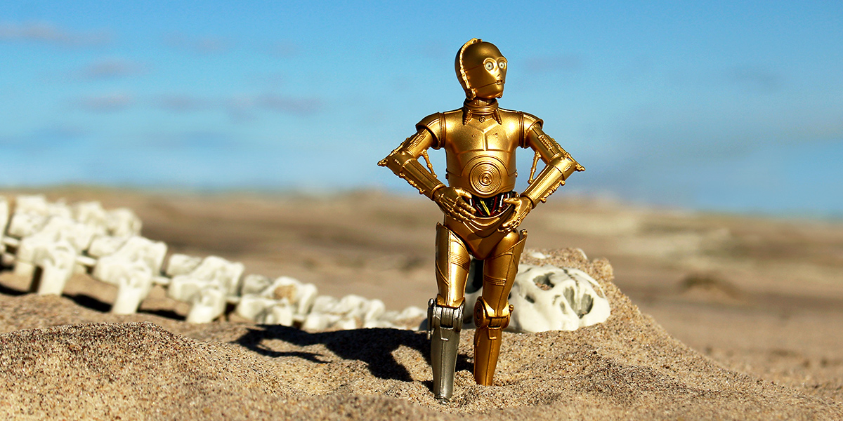 C-3PO C-3P0 Threepio droid Star Wars the Black Series figure with Krayt dragon bones skeleton on Tatooine