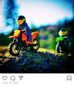 LEGO Minifig motorcyclist and riding buddy on a rocky ridge