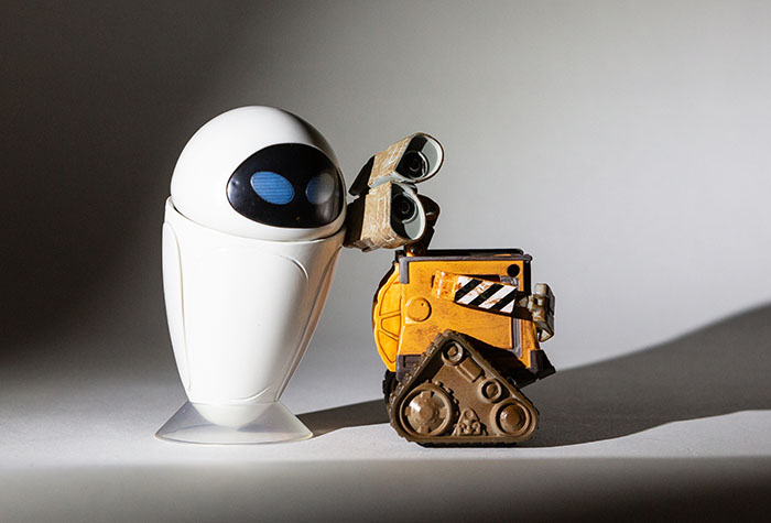 Wall-E and Eve lit with a single Lume Cube and snoot centered on them.