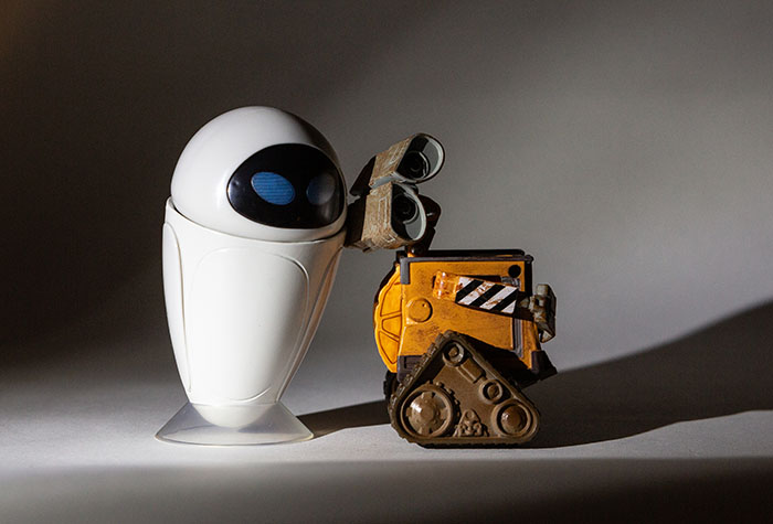 Wall-E and Eve lit with a single Lume Cube with a tight grid and snoot centered on them.