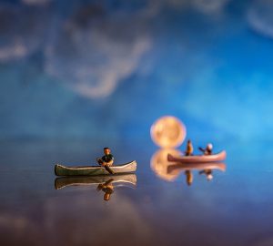 N scale canoes against a reflective surface