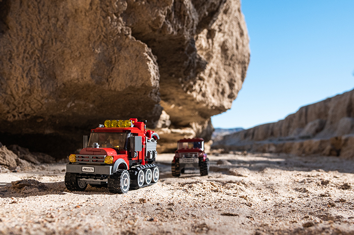 The adventurers begin their journey in Lego trucks.