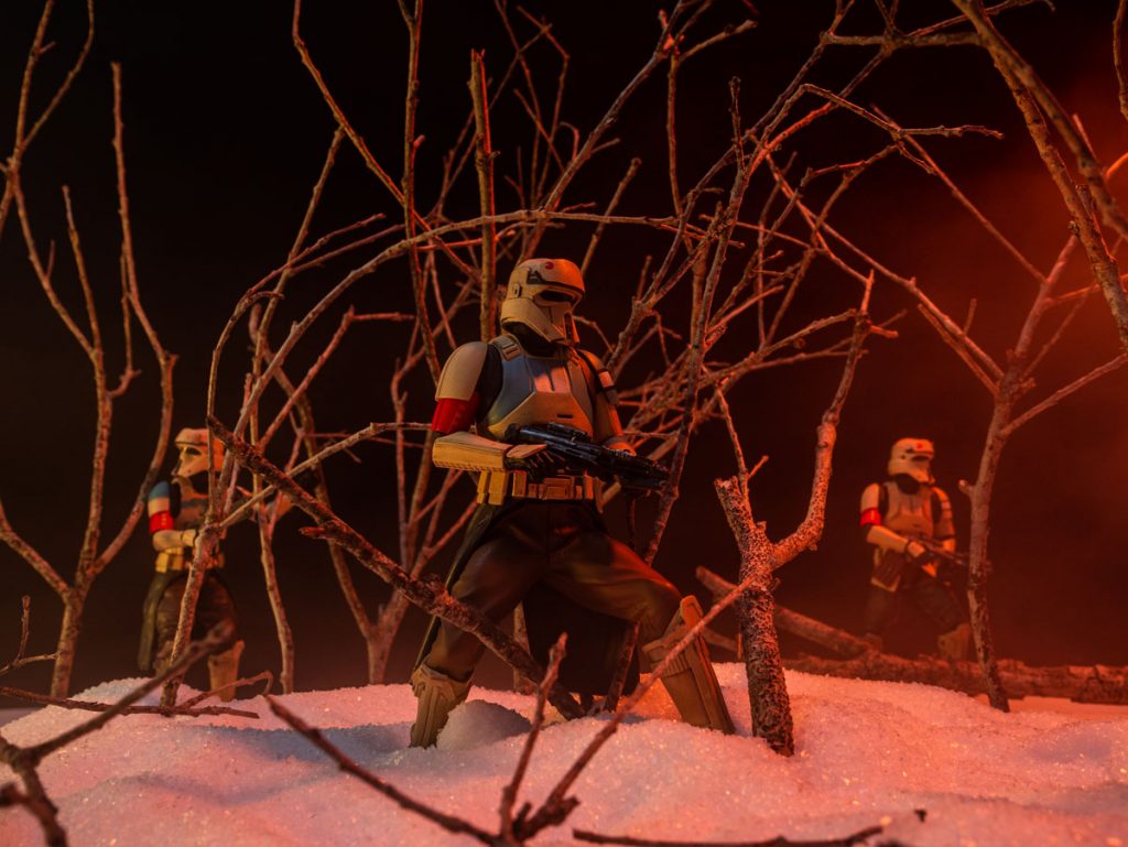 Scarif troopers patrolling through the misty woods in the snow.