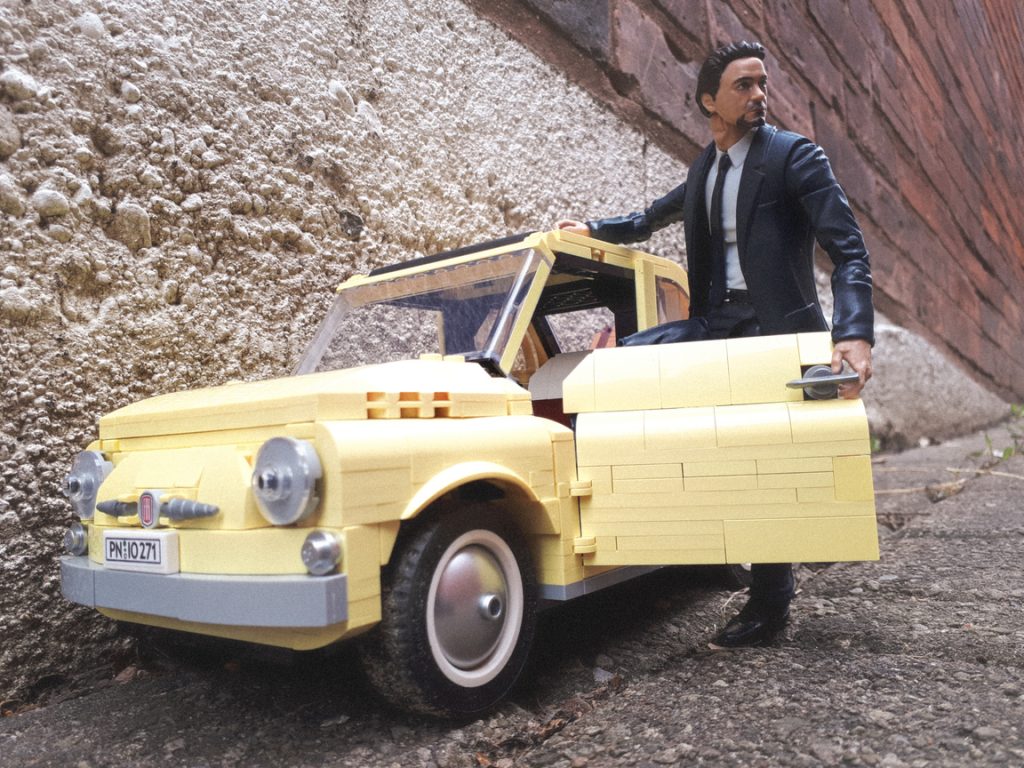 A man opens the door of the LEGO Fiat 500