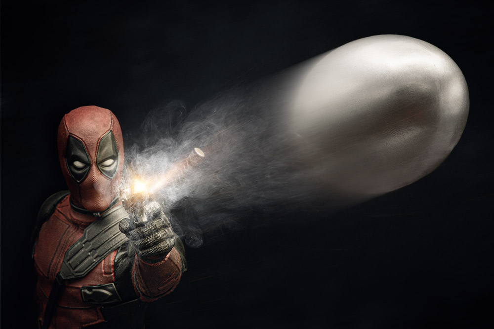 Deadpool shooting a bullet at the camera