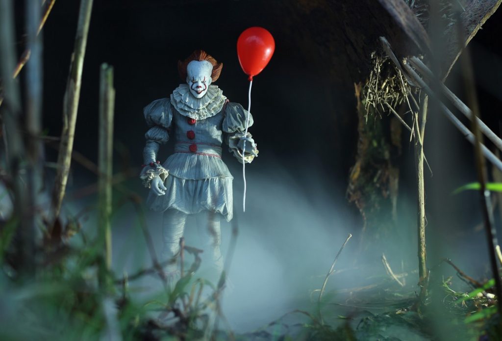 NECA Pennywise action figure with balloon in tunnel