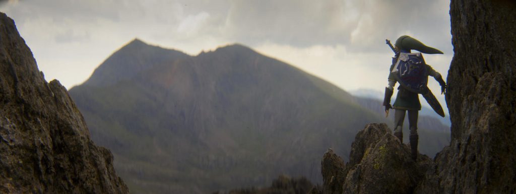 Link action figure standing on the rock, looking at the mountain in the distance