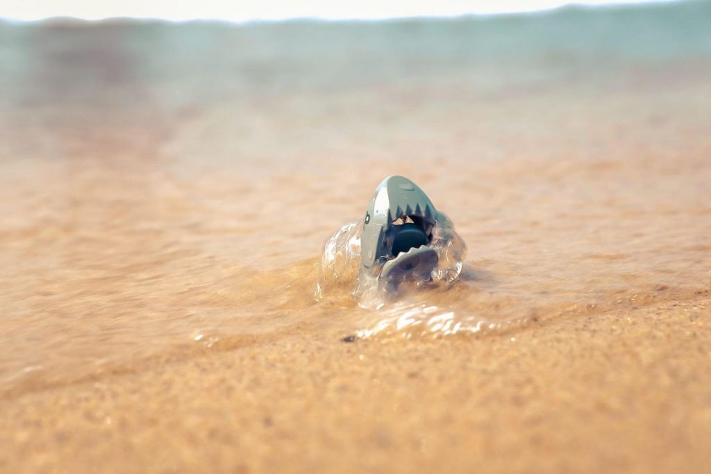 LEGO shark figure emerging from the waves at the beach