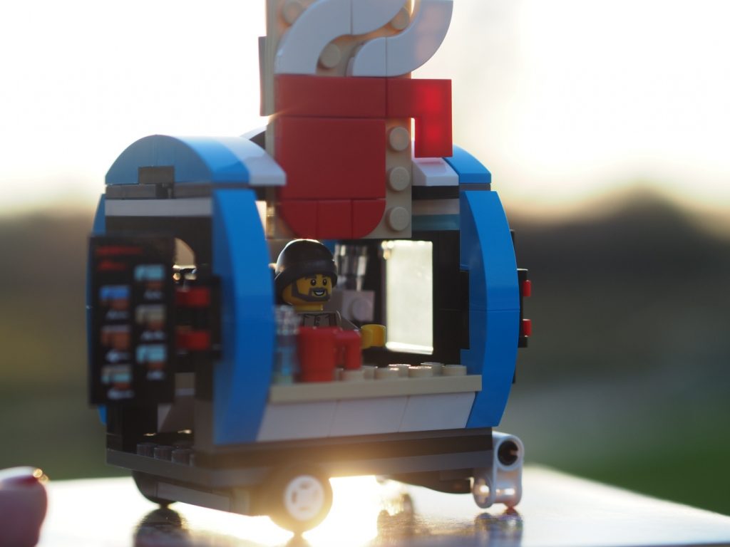 A LEGO coffee cart set in the sunset