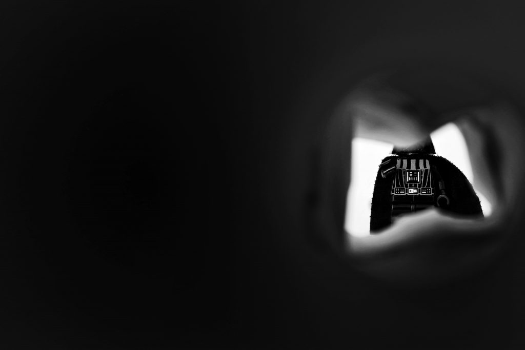 Black and white picture of LEGO minifigure in James Bond opening sequence-like perspective
