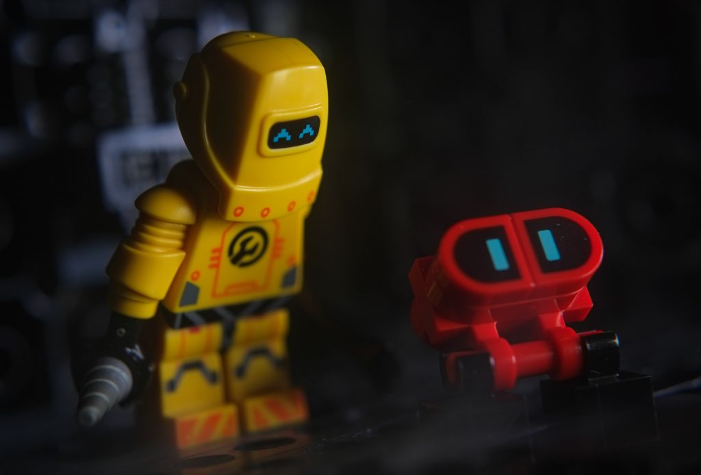 LEGO yellow robot minifigure and red buildable minibot