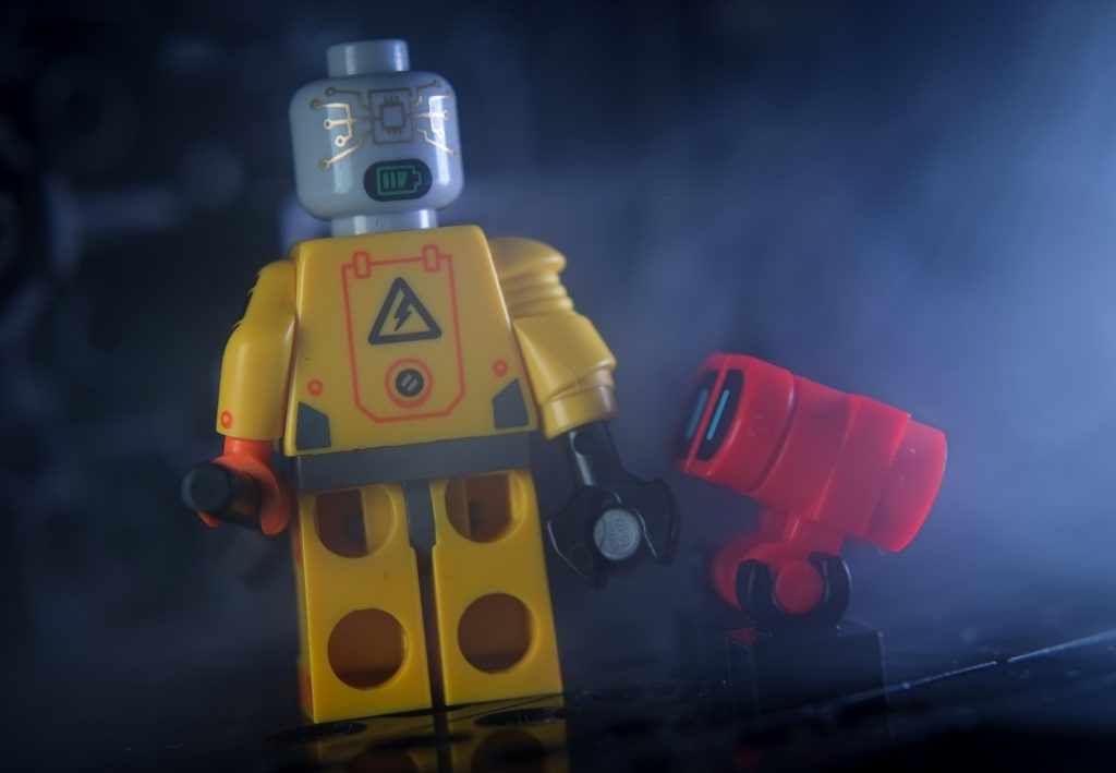 LEGO yellow robot minifigure and red buildable minibot