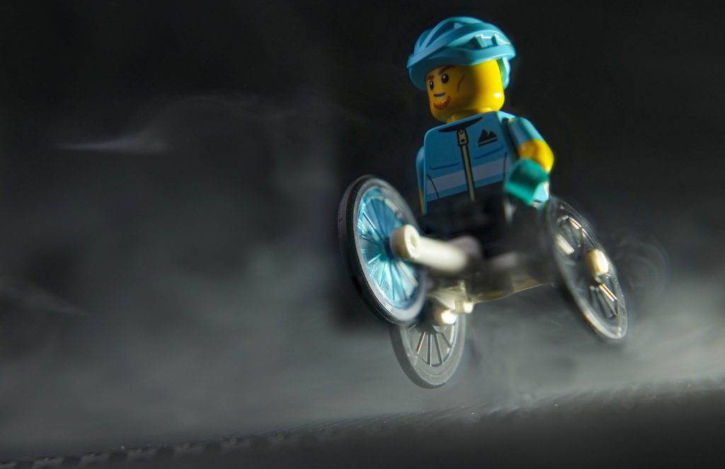 A male athlete minifigure on the three-wheeled sport  wheelchair 