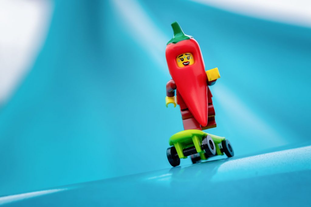 LEGO red chili suit girl minifiure on LEGO skateboard