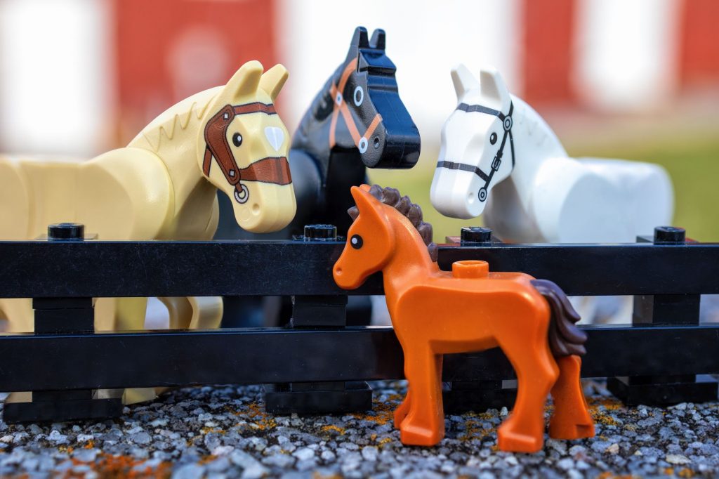 LEGO moulded foal looking at three LEGO horses