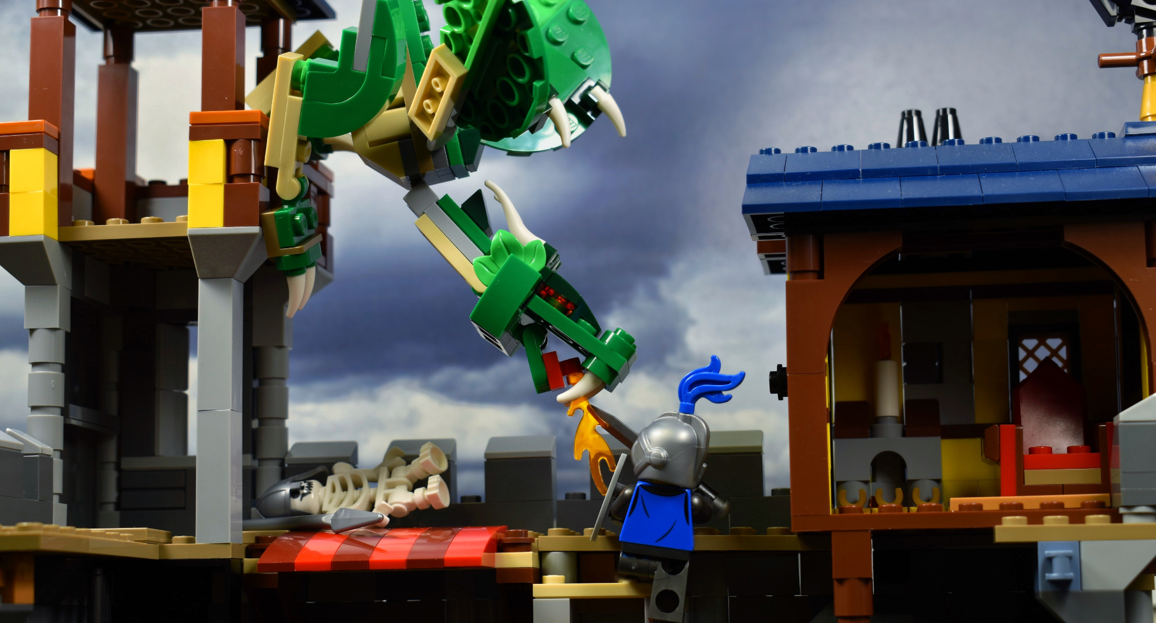 LEGO brick built dragon attacking a LEGO castle walls