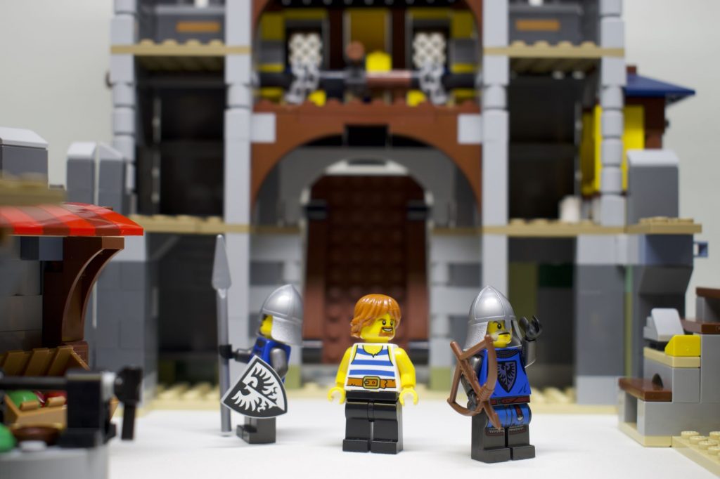 LEGO two Black Flacon knights and blacksmith minifigures in front of castle set