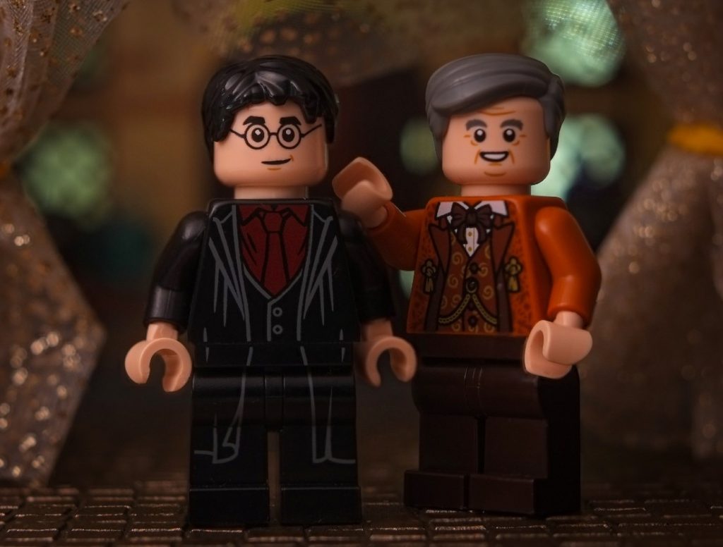 Harry Potter LEGO minifigure and Horace Slughorn LEGO minifigure posing together for photo
