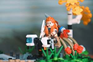 Aloy minifigure with spear and bow, from LEGO Horizon Forbidden West: Tallneck (76989) set sittong on the watcher