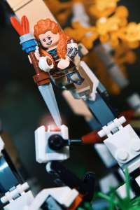 Aloy minifigure with spear and bow, from LEGO Horizon Forbidden West: Tallneck (76989) set, jumping over watcher