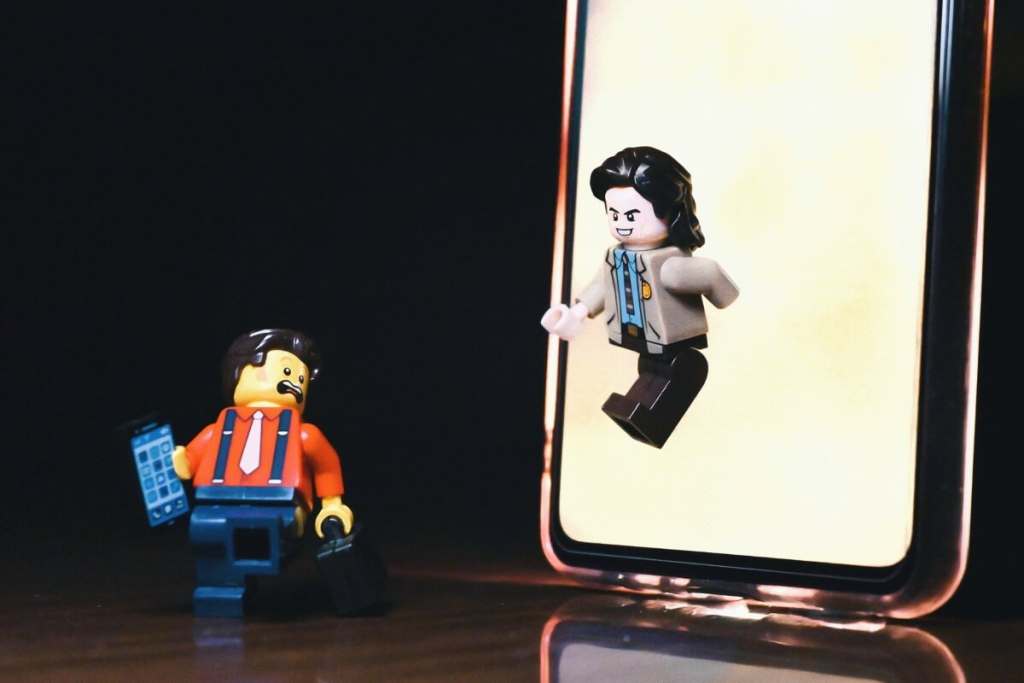 LEGO Loki minifigure "emerging" from the smartphone screen which looks like a interdimensional portal