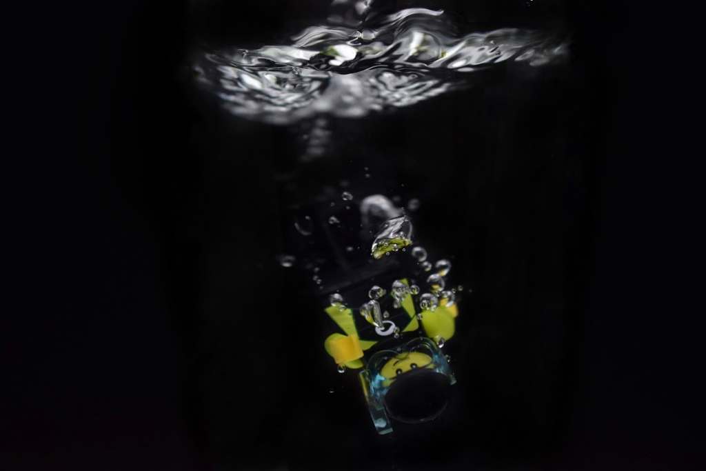 A LEGO diver minifigure submerging into the water

author: Tao Liao