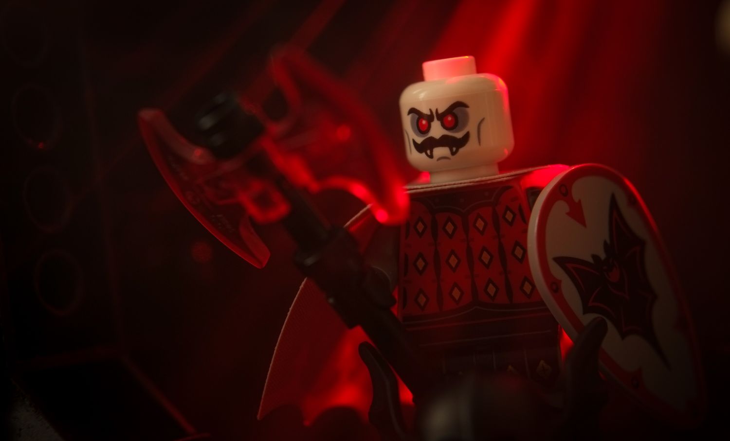 A LEGO Bat Lord minifigure holding a trans red axe.