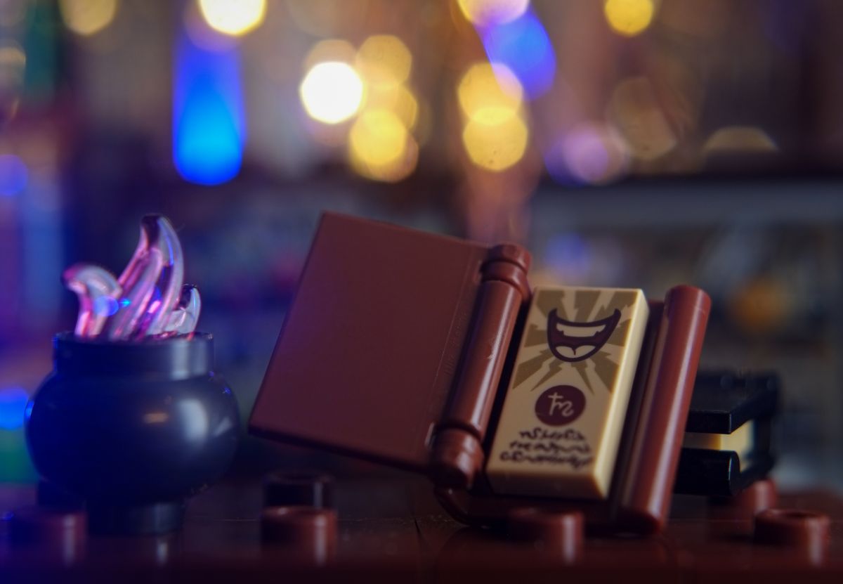 close-up of cauldron and magic book on the table