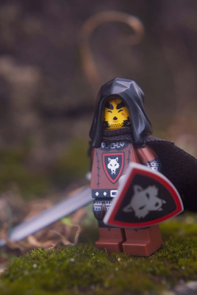 Wolfpack Beastmaster minifigure in natural environment with whistle face expression, calling his wolf.