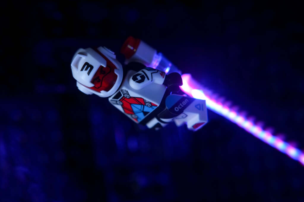 Jetpack Racer minifigure flying in the dark, with light-painting effect for jestpack exhaust.