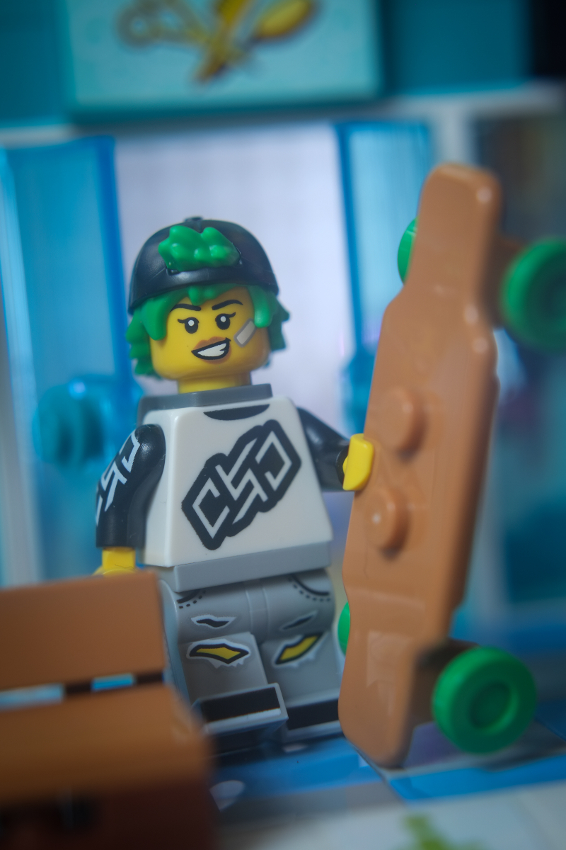 Longboarder minifigure leaves hairdresser with longboard in her hand.