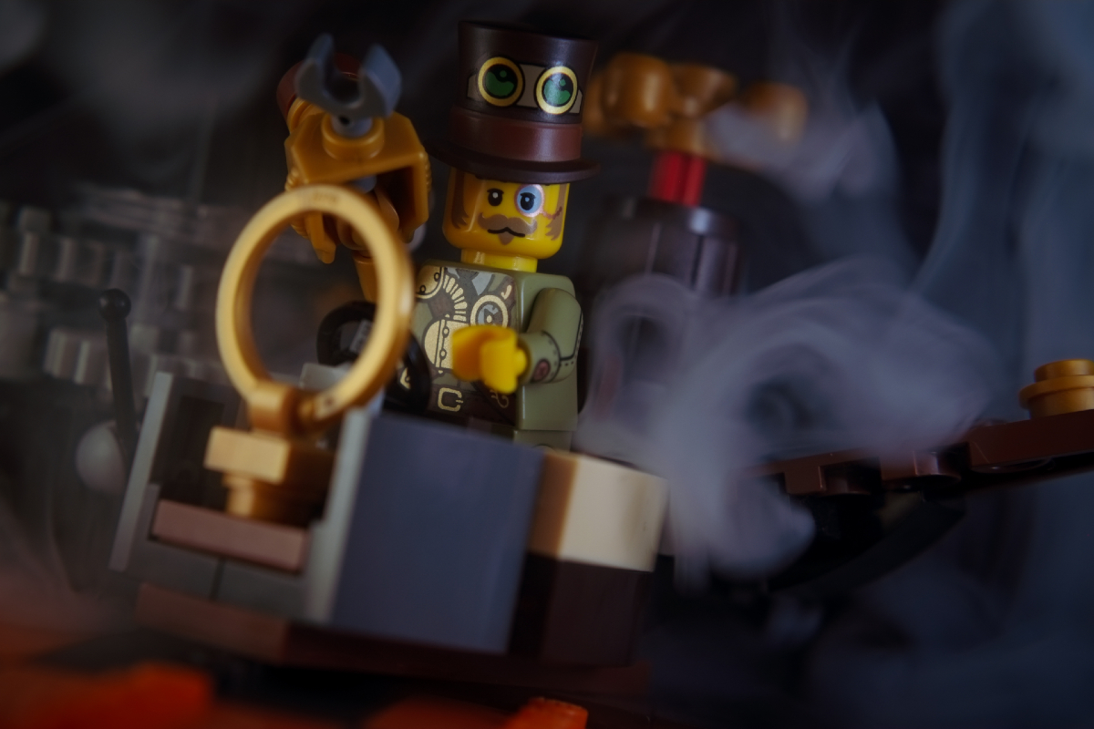 Steampunk Inventor minifigure sits in a time machine, shrouded in steam, ready to leap through time.